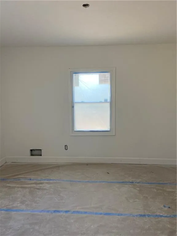 Empty room featuring baseboards