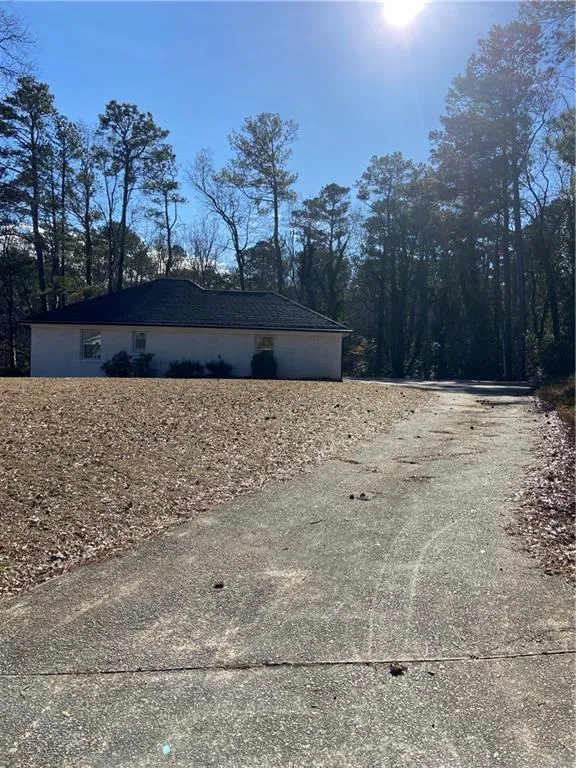 View of home's exterior featuring driveway