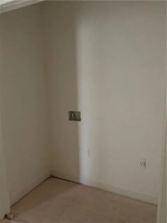 Unfurnished room with baseboards