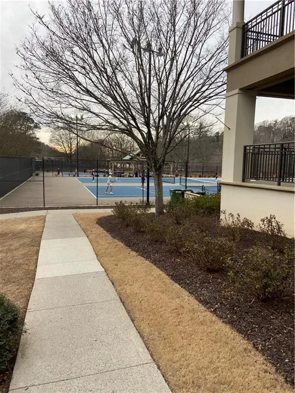 View of yard with a tennis court