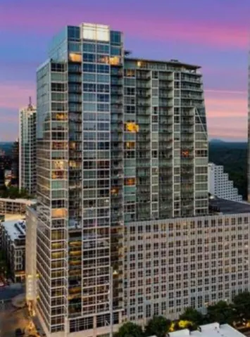 Contemporary high-rise building featuring a glass and concrete facade