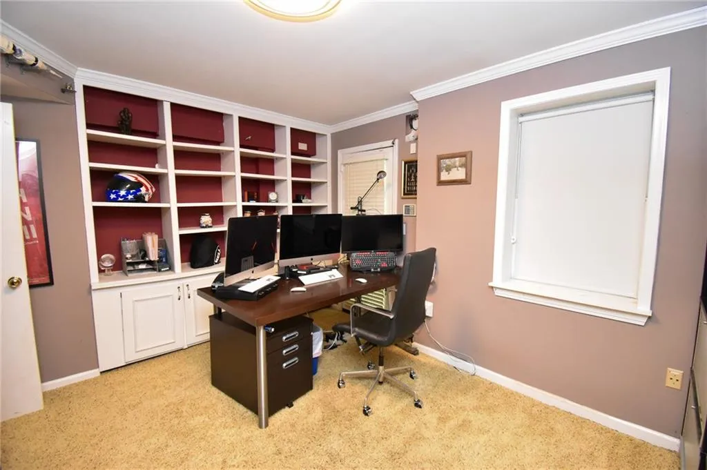 Bedroom / office with built in cabinets.