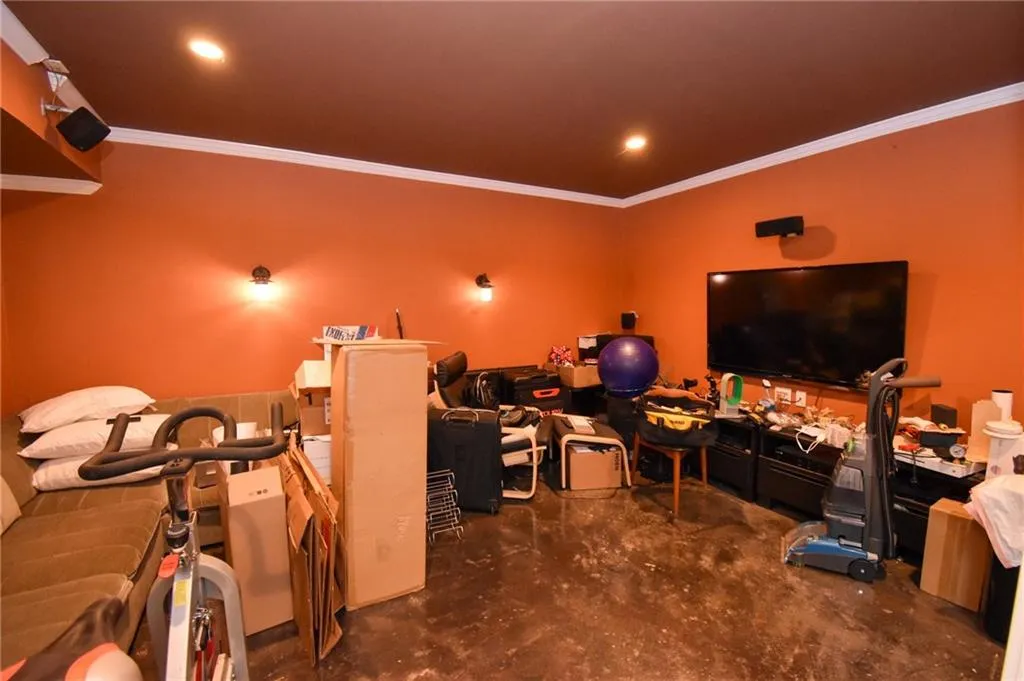Entertainment room with acid stained floors and surround sound.