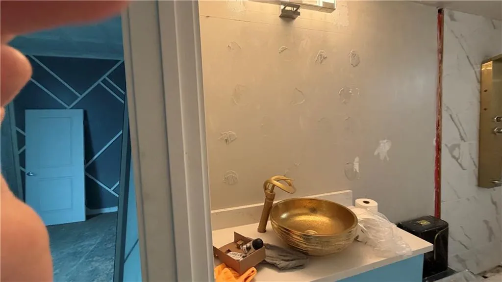 Full bath with vanity and a marble finish shower