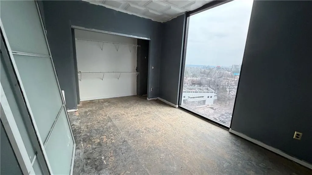 Unfurnished bedroom featuring an ornate ceiling, a closet, and expansive windows