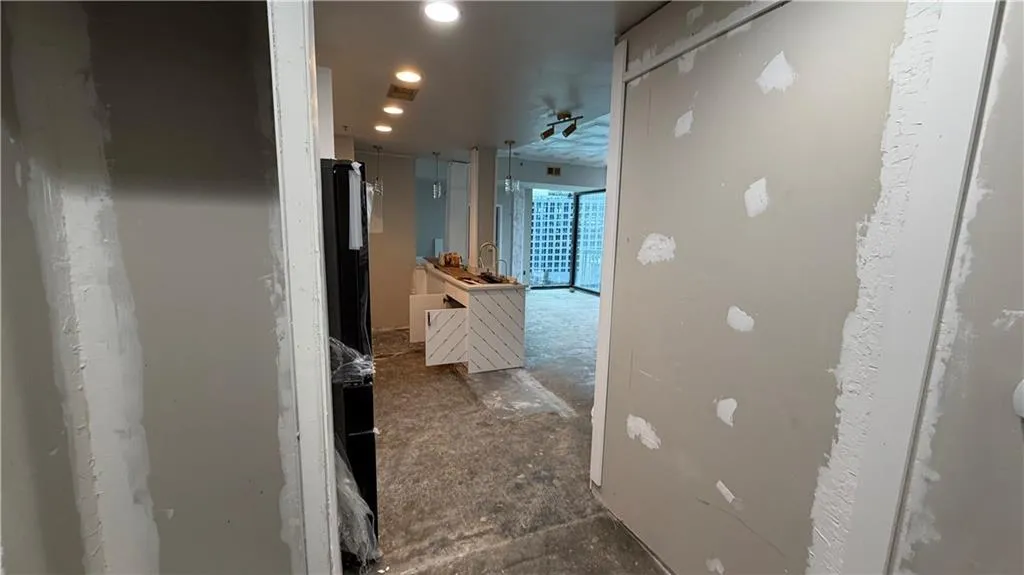 Hallway with recessed lighting and a sink