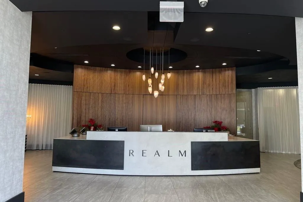 Reception with recessed lighting and wood walls