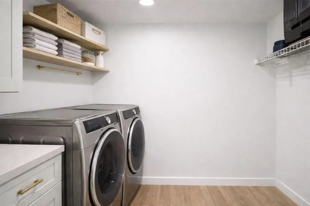 Washroom featuring light wood-type flooring, independent washer and dryer, and recessed lighting