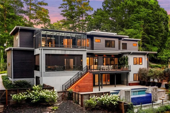 Multi-level exterior with dark horizontal siding and light-toned stucco