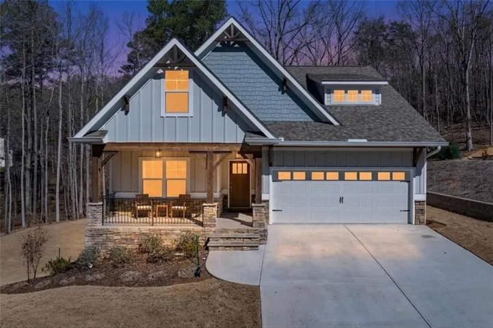 Craftsman-style exterior featuring a blend of board and batten siding, shake siding, and stone accents