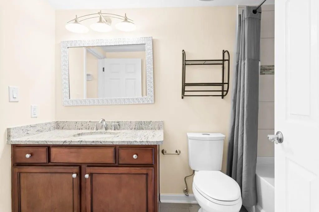 Bathroom featuring vanity, baseboards, and toilet