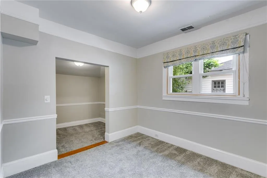 Unfurnished room with light carpet