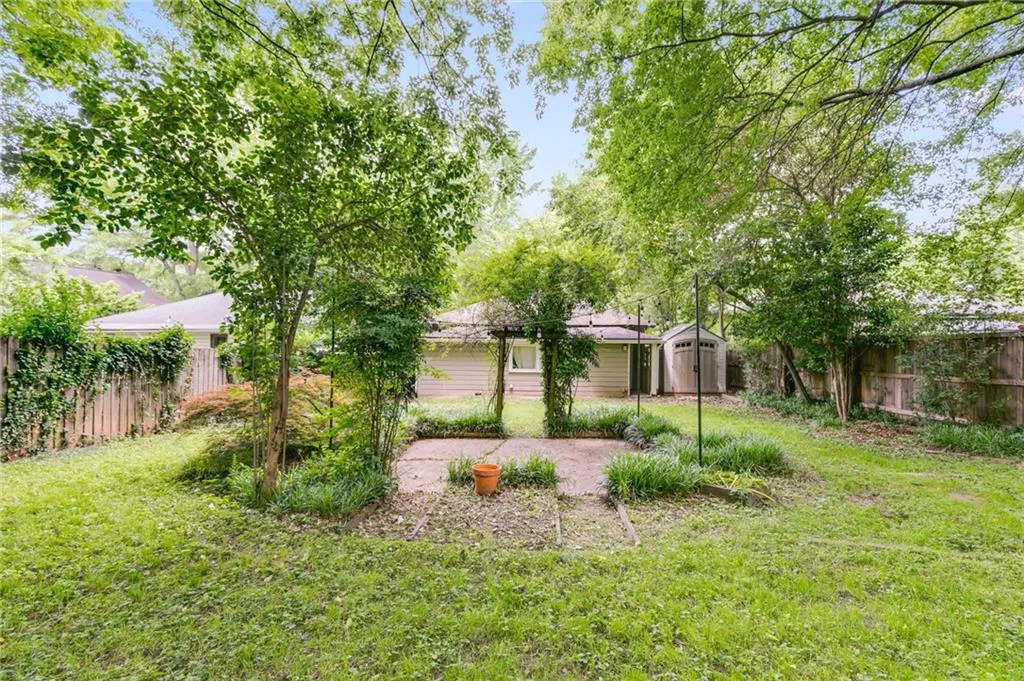 View of yard with a shed and a patio area