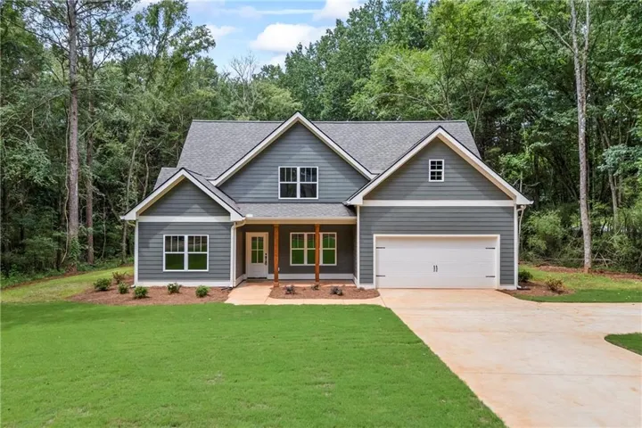 Modern Craftsman-style home featuring gray horizontal siding, white trim, and a prominent two-car garage