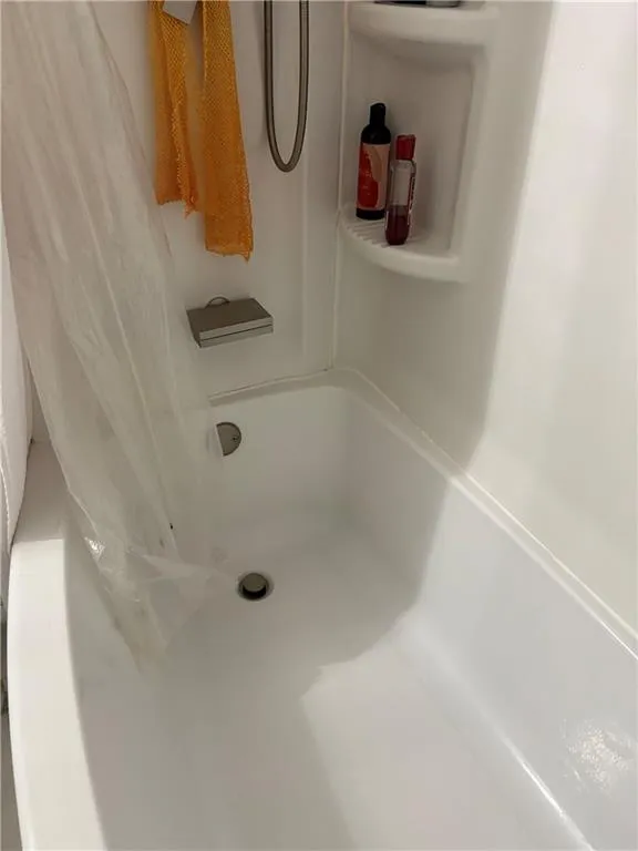 Bathroom with shower / bath combo with shower curtain