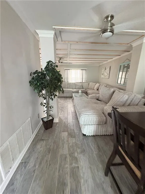 Bedroom featuring baseboards and wood-type flooring