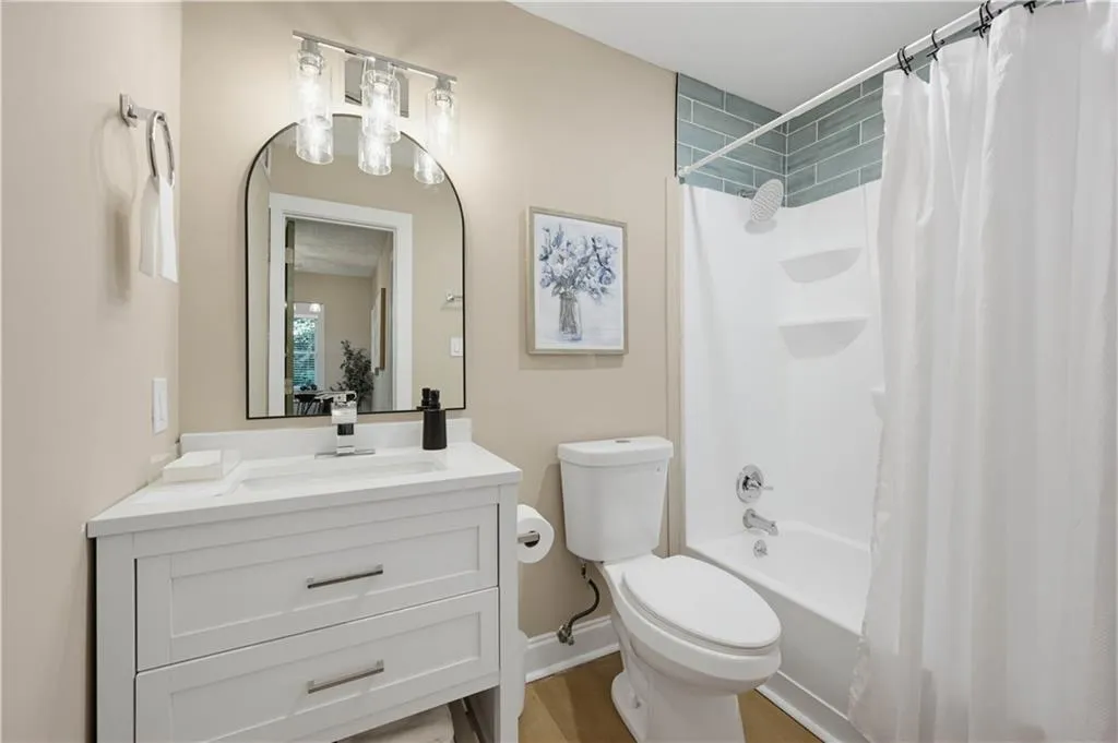 White vanity with a single basin sink and chrome faucet