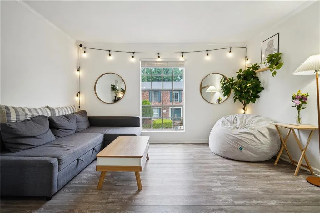 Living room with crown molding and hardwood / wood-style flooring