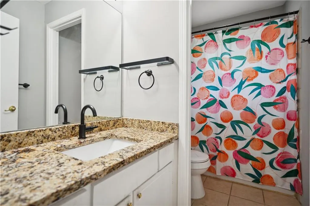Bathroom with tile floors, vanity, and toilet