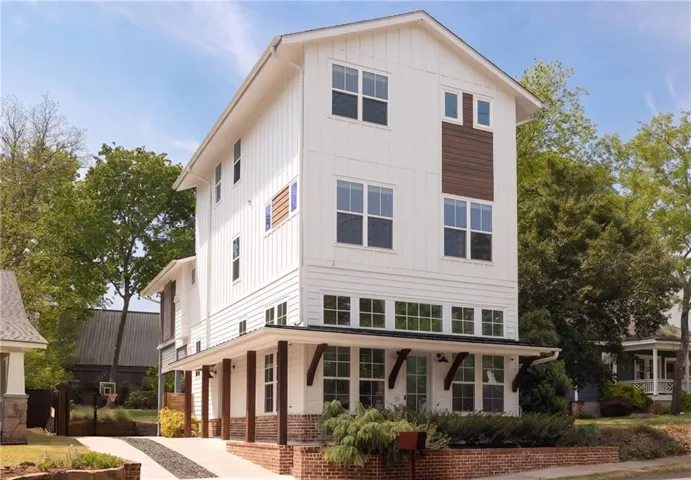 Modern vertical siding exterior with wood-tone accents and multiple large windows