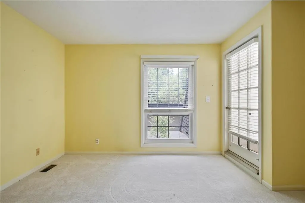 Additional bedroom with closet featuring a French door to rooftop patio over garage.