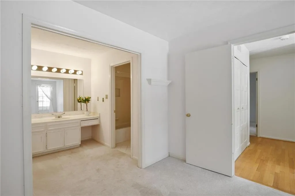 View from primary bedroom to bathroom and hallway