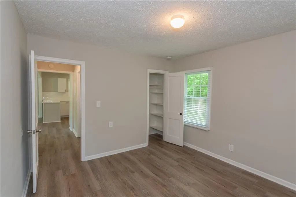 Kitchen featuring stainless steel appliances, a sink, light wood-type flooring, and decorative backsplash