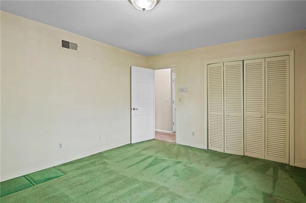 Unfurnished bedroom featuring carpet flooring and a closet