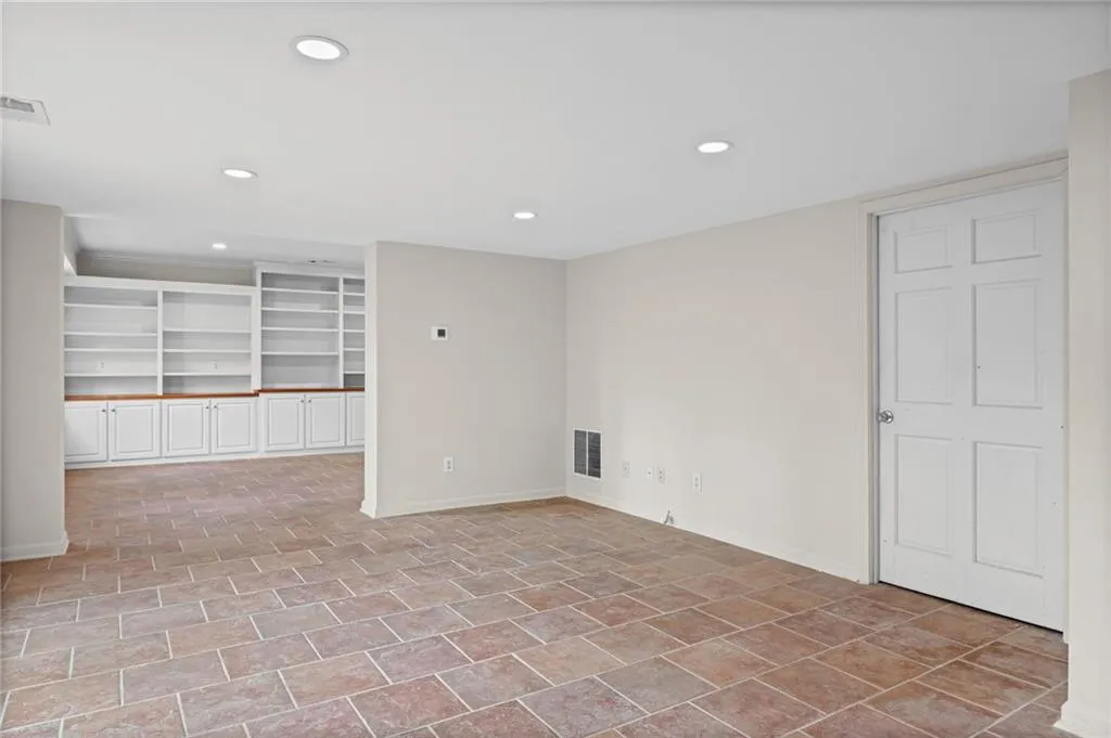 Spare room featuring recessed lighting and built in shelves