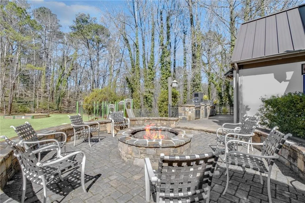 View of patio / terrace featuring an outdoor kitchen and a fire pit