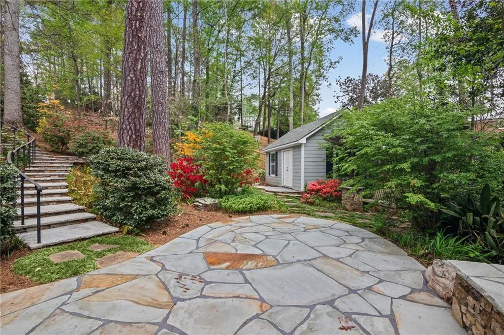 View of patio featuring an outbuilding and stairs