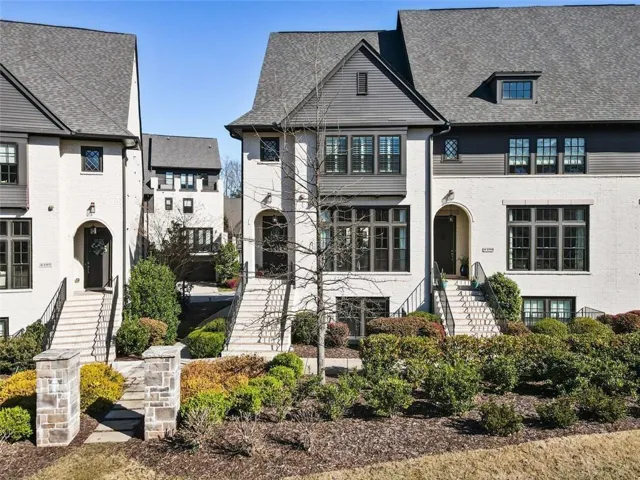 End Unit! French country inspired facade with roof with shingles and brick siding.