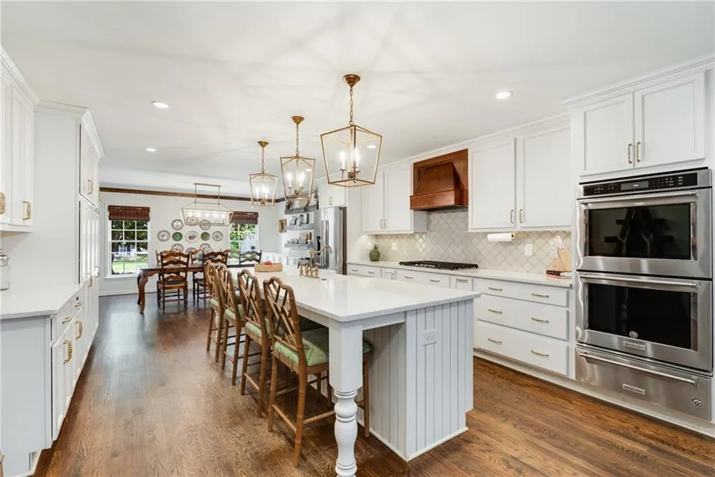 ALTERNATE KITCHEN VEIW TO DINNING ROOM | DOUBLE OVENS + WARMING DRAWER | CUSTOM VENT HOOD | 5 BURNER COOK TOP | STORAGE