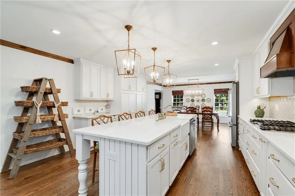 MASSIVE KITCHEN ISLAND ANCHORS KITCHEN ENTERTAINING | CUSTOM LIGHTING | STORAGE | VIEW TO DINING ROOM | CUSTOM WINDOW TREATMENTS