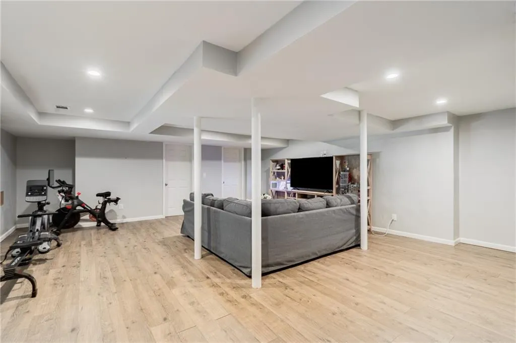 ALTERNATE VIEW OF FINISHED TERRACE LEVEL | STORAGE | OPTIONAL FITNESS OR STORAGE ROOM WITH DIRECT ACCESS TO REAR YARD + COVERED PATIO