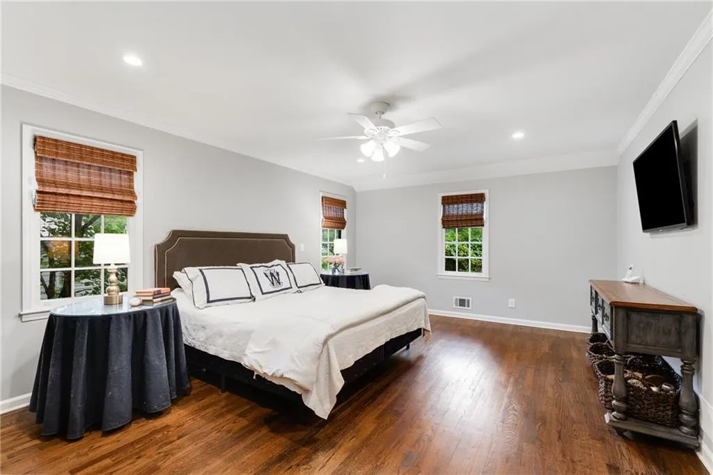 PRIMARY BEDROOM ON MAIN FLOOR | CUSTOM WINDOW TREATMENTS | HARDWOOD FLOORS | NEUTRAL PAINT