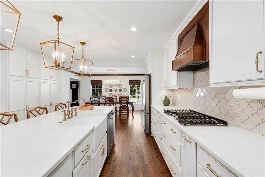STORAGE | TRASH + RECYCLING PULL OUT | SPICE RACK | DEEP POT + PAN STORAGE | CUSTOM BRASS SINK FIXTURE | GARBAGE DISPOSAL AIR SWITCH | HARDWOOD FLOORS