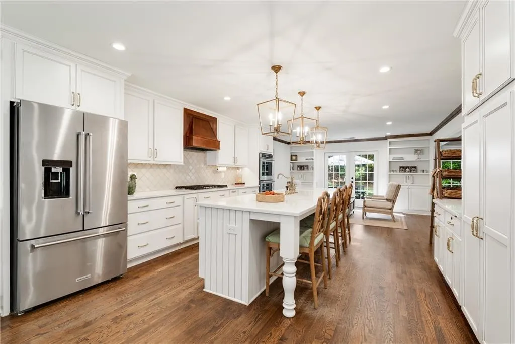 CUSTOM DREAM KITCHEN ACHORS YOUR HOME | QUARTZ COUNTERS | HARDWOOD FLOORS | CUSTOM LIGHTING | DUAL PANTRIES | VIEWS TO BACKYARD | STORAGE