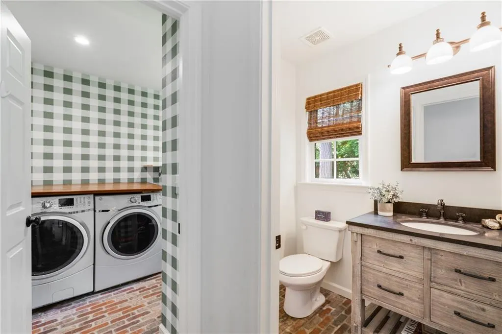 VIEWS OF LAUNDRY + POWDER ROOMS | CUSTOM WINDOW TREATMENTS | STORAGE | LAUNDRY ROOM FEATURES SINK + APPLIANCE CHARGING STATION | CUSTOM WALLPAPER