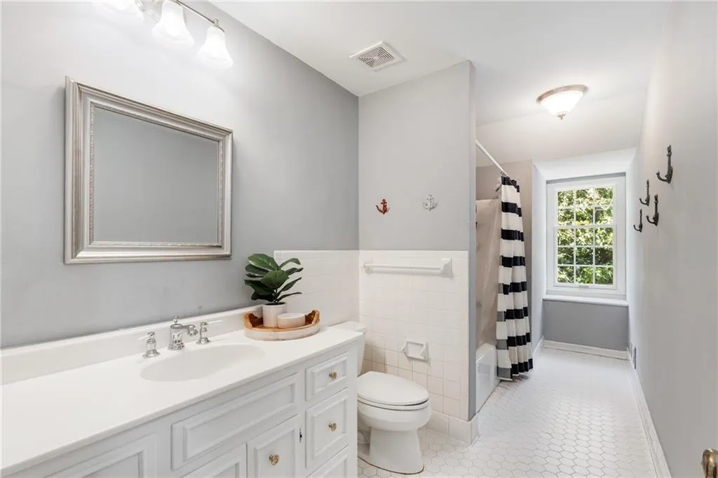 HALL BATH UPSTAIRS | NEUTRAL TILE | STORAGE | BRIGHT NATURAL LIGHT