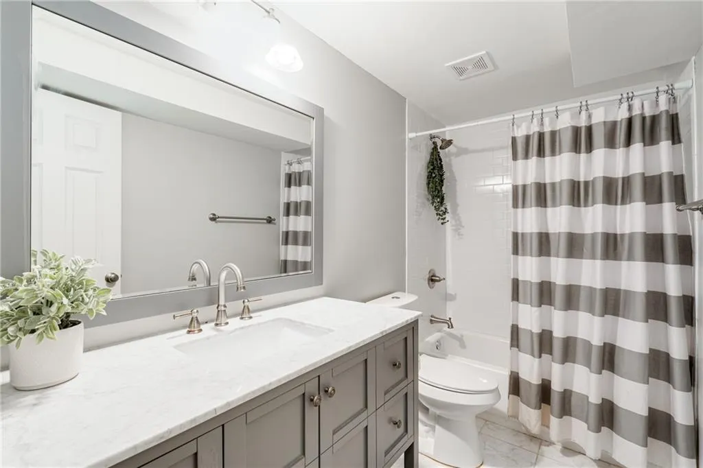 TERRACE LEVEL FULL BATH | STORAGE | QUARTZ COUNTERS | NEUTRAL TILE | NEUTRAL PAINT