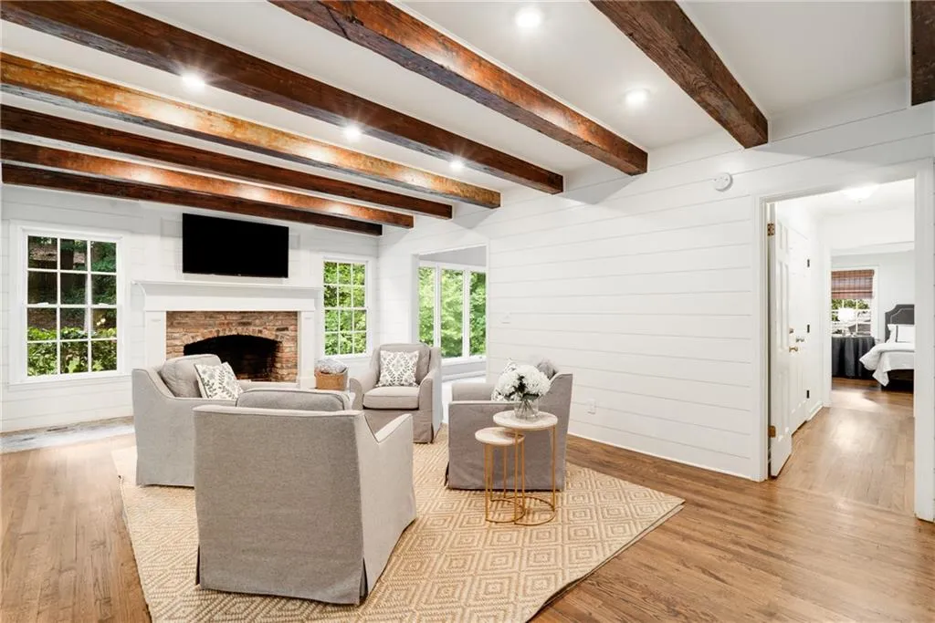 VIEW FROM LIVING ROOM TO PRIMARY WING | HARDWOOD FLOORS | CUSTOM RECLAIMED BEAMS | CUSTOM SHIPLAP DETAIL | VIEWS TO PRIVATE WOODED YARD