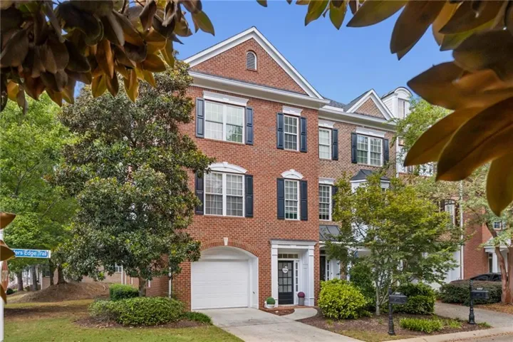 Brick exterior with multiple gables and dormers. End-unit with extended garage, much larger than other 2/2/1s in the community.