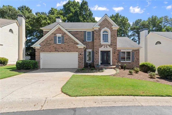 Brick facade with a white garage door