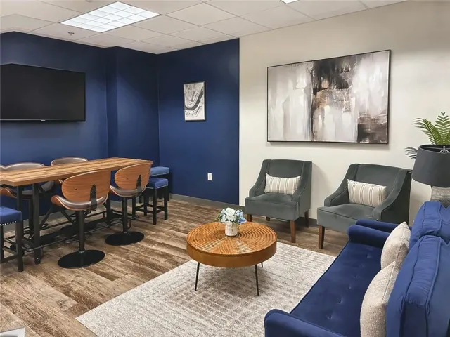 Common seating area with wood-finish flooring, recessed lighting, and lounge seating