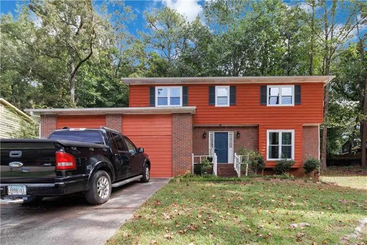 Two-story exterior with horizontal siding and brick accents