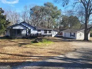 Ranch-style residence featuring a screened porch and an outbuilding