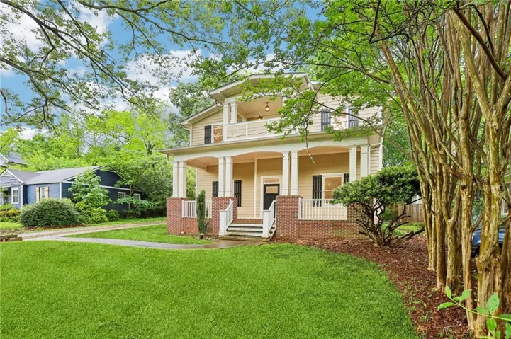 Front facade with elegant symmetry and inviting covered porch.