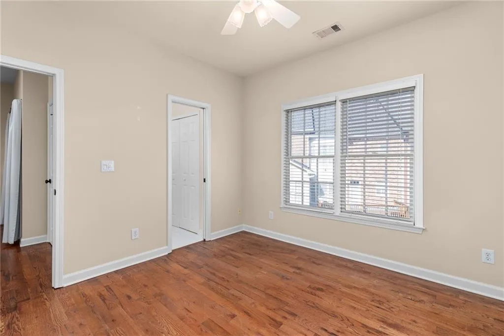 Unfurnished bedroom featuring baseboards, visible vents, and wood finished floors