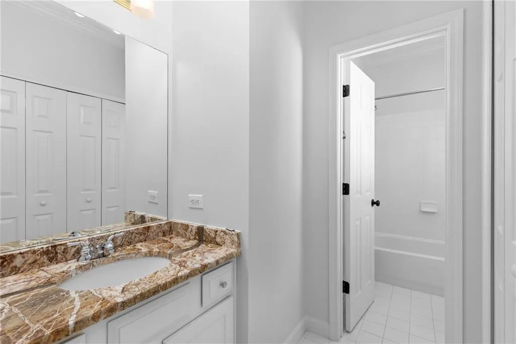 Full bathroom featuring vanity, shower / bathing tub combination, a closet, baseboards, and tile patterned flooring